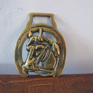 Vintage horse brass. Horses head set in a horse shoe