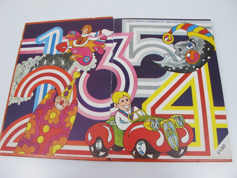 May include: A vintage children's book illustration featuring colorful numbers and whimsical characters. The artwork includes a clown, a car, a plane, and a smiling moon, all set against a dark purple background with rainbow and striped accents.