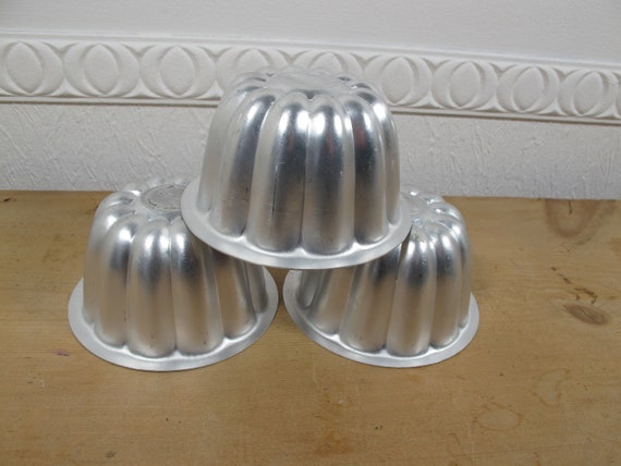 Tres pequeños moldes de gelatina de aluminio vintage. Arranca tu bamboleo -   México
