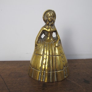 Vintage brass crinoline lady bell. Nice and heavy 4.5 inches tall