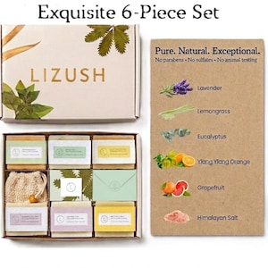May include: A 6-piece set of soaps in a box with the brand name "LIZUSH". The box contains six bars of soap, a loofah, and a card listing ingredients like lavender, lemongrass, and grapefruit. The box is beige with green and brown accents.