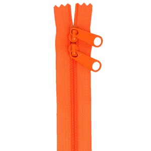May include: A bright orange zipper with two orange pull tabs.