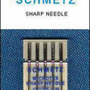 May include: A pack of five silver sewing machine needles, labeled "Schmetz Microtex Sharp Needle" and "KR 100/14 20/8", on a white background.