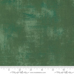 May include: Green fabric with a textured, distressed look. The fabric has a subtle, faded pattern and a slightly rough feel.