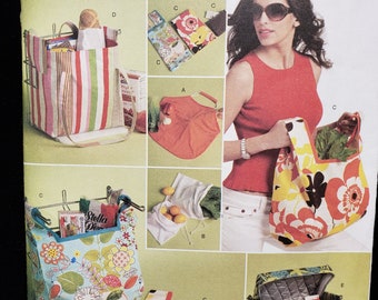 May include: A Butterick sewing pattern, B5338, featuring various tote bags and a cooler bag. The bags showcase diverse floral and striped patterns. The pattern includes a striped tote, a floral tote, and a red tote bag.