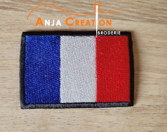 May include: Embroidered patch featuring the French flag design with blue, white, and red vertical stripes. The patch has a black border and the text "ANJA CREATION BRODERIE" in orange and white.