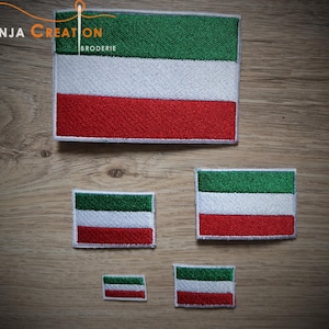 Peut inclure: Quatre patchs brodés du drapeau de la Guinée équatoriale de différentes tailles. Les patchs sont sur une surface en bois. Le plus grand patch mesure environ 10 cm de large et 7,5 cm de haut. Le plus petit patch mesure environ 2,5 cm de large et 2,5 cm de haut.