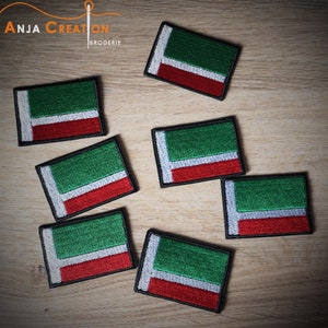 May include: Seven embroidered patches of the flag of Russia. The patches are green, white, and red with a black border.
