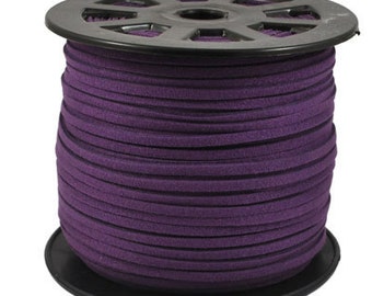 Puede incluir: Un carrete de cordón de ante morado. El cordón está enrollado alrededor de un carrete de plástico negro. El ante es de un tono morado intenso y rico. El carrete tiene una serie de agujeros alrededor de la parte superior e inferior.