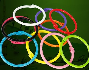 May include: Assortment of colorful metal rings with a locking mechanism. The rings are in various colors, including white, black, blue, yellow, orange, pink, red, and purple.
