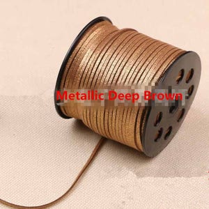 May include: A spool of metallic deep brown leather cord. The cord is wound around a black plastic spool with holes for easy dispensing.