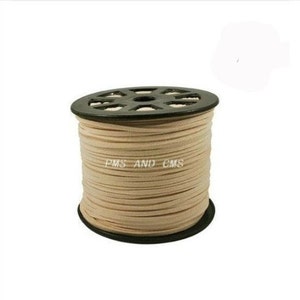 Op de afbeelding: Een spoel beige suède koord, gewikkeld om een zwarte plastic spoel met een label met de tekst "PMS AND CMS".