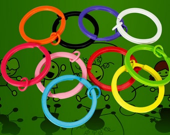 May include: Assortment of colorful metal key rings. The key rings are in various colors, including orange, red, pink, blue, green, yellow, purple, black, and white.