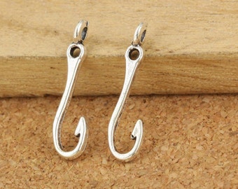 May include: Two silver-toned metal fish hook charms with a loop at the top for attaching to jewelry or other crafts.