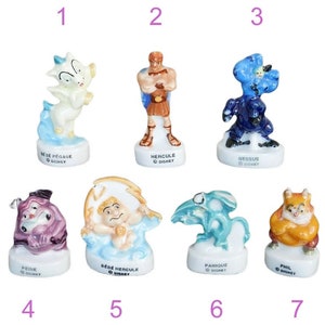 May include: Set of seven ceramic figurines from the Disney movie Hercules. The figurines depict characters from the movie, including Hercules, Pegasus, Phil, Pain, Nessus, and Baby Hercules. Each figurine is painted in bright colors and has a Disney logo on the base.