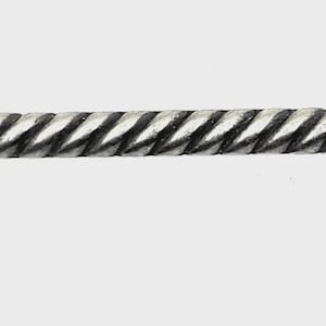 May include: A silver-toned cabinet pull with a twisted center and star-shaped ends. The hardware is designed with a rustic aesthetic, featuring a textured, aged appearance. The pull is designed for easy installation on drawers or cabinet doors.