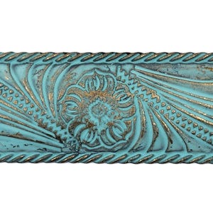 May include: A rectangular metal bar with a turquoise patina finish and a deeply embossed floral and scroll pattern. The edges feature a rope-like texture, and the recessed areas of the design show a dark, metallic bronze-toned base color.