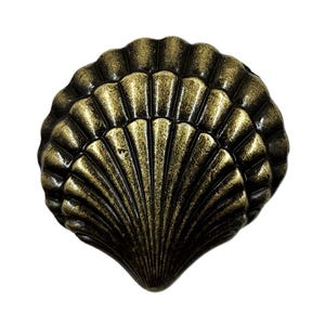 May include: A decorative, antique-style seashell-shaped cabinet knob. The knob is made of metal with a dark bronze and gold finish. The seashell design features detailed ridges and a textured surface, perfect for coastal or nautical decor.