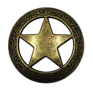 May include: A round, antique brass-colored star-shaped button with a five-pointed star in the center. The button has an ornate, swirling design around the star's perimeter. The button is likely used for decorative purposes.