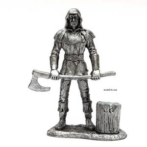 May include: A pewter figurine of a hooded figure holding an axe, standing on a base with a log. The figure is wearing a long hooded robe and has a stern expression. The axe is held in a threatening manner. The figurine is a depiction of a medieval executioner.