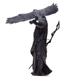 May include: A black and silver statue of a figure holding a bird with outstretched wings. The figure is wearing a long robe and holding a spear.