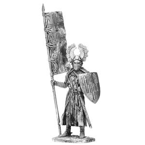 May include: A silver miniature figure of a knight in armour holding a flag and a shield. The knight is wearing a helmet with a crest and a long, flowing robe. The flag is white with a red cross. The shield is round and has a red and white design.