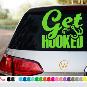 May include: Green vinyl car decal with the text "Get Hooked" and a fish and hook graphic. The decal is on the back window of a silver car.