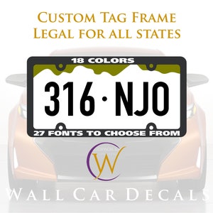 May include: A black license plate frame with a white background and the text "CUSTOM TAG FRAME LEGAL FOR ALL STATES 18 COLORS 316-NJO 27 FONTS TO CHOOSE FROM" in black. The frame is on a car.