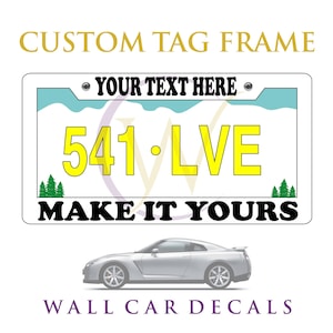 May include: A rectangular license plate frame featuring the text YOUR TEXT HERE at the top and MAKE IT YOURS at the bottom. The center displays the yellow text 541 LVE against a white background with light blue mountain peaks and green pine trees.