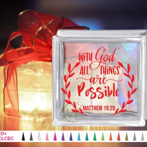 May include: A glass block with a red vinyl decal that reads "With God all things are possible Matthew 19:26".