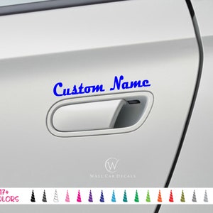 May include: A blue decal with the words "Custom Name" in a cursive font is displayed on a car door. The decal is above the door handle. The image also shows a variety of color options for the decal.