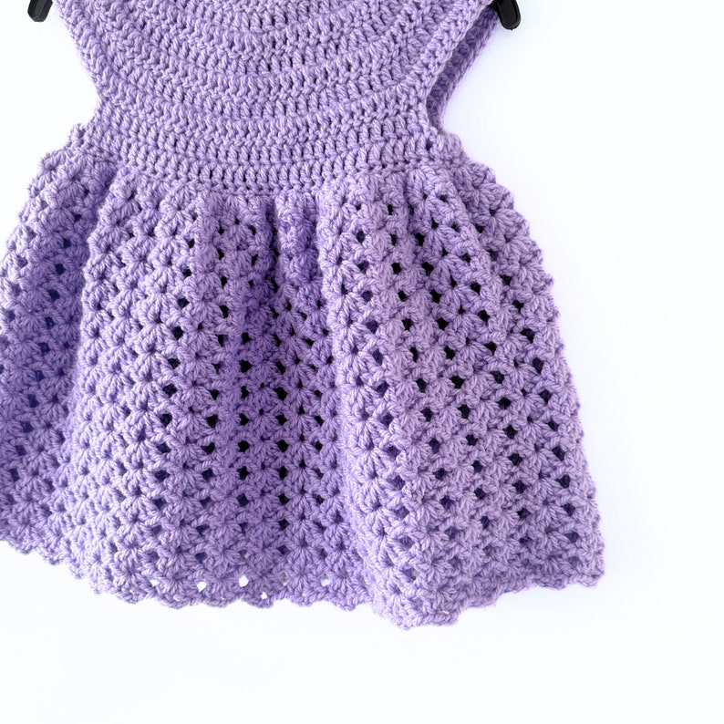 May include: A purple crocheted dress with a scalloped hem.