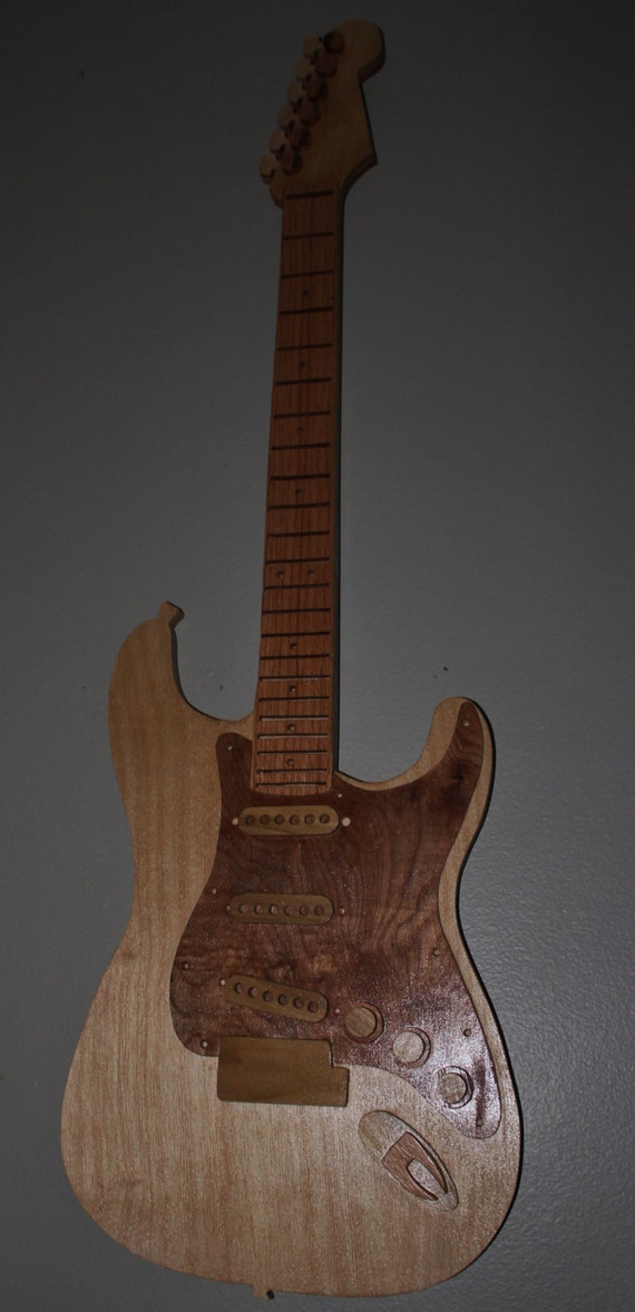 Guitar handmade solid wood finish retains the wood grain. Etsy