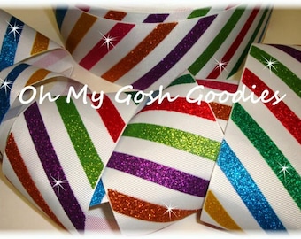 May include: White ribbon with diagonal stripes in various colors, including red, green, purple, orange, and blue, each with glitter accents. The text "Oh My Gosh Goodies" is visible on the ribbon.