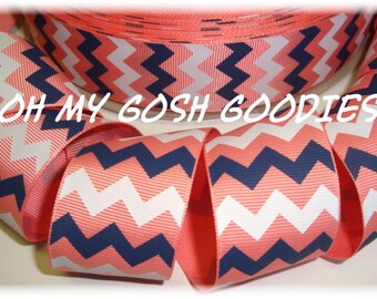 May include: Coral, white, and navy blue chevron patterned ribbon. The ribbon is 2.5 inches wide and is made of grosgrain.