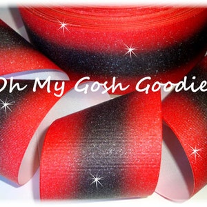 May include: Red and black ombre glitter ribbon with a white backing. The ribbon has a gradient effect with red at the top and black at the bottom. The ribbon is covered in glitter.