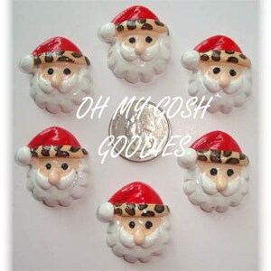 May include: Six small, white ceramic Santa Claus ornaments with red hats and black and brown leopard print trim. The ornaments are on a white surface.