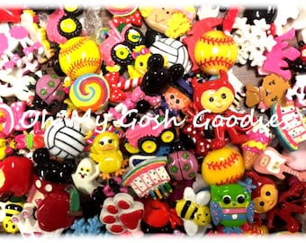 May include: A collection of colourful, small, resin cabochons featuring various themes, including animals, food, sports, and cartoon characters. The cabochons are perfect for crafting projects, such as jewellery making, scrapbooking, and resin art.