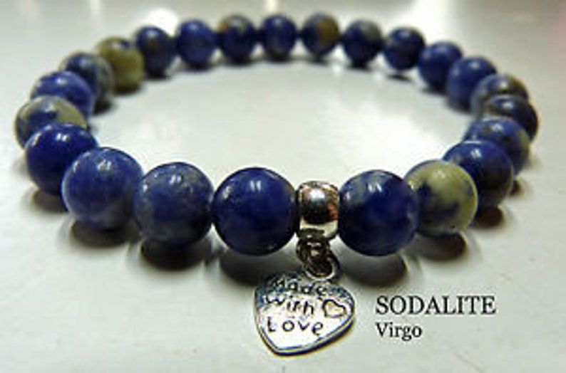 May include: A blue sodalite gemstone bracelet with a silver heart charm that says "Made with love". The bracelet is labeled "Sodalite Virgo".