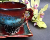Porcelain Tea Cup and Saucer In Red and Blue Iron Spot Glaze, Hand Built Ceramic Cup For Tea Lovers. 3.75 in. tall, holds 10 oz. Food Safe.