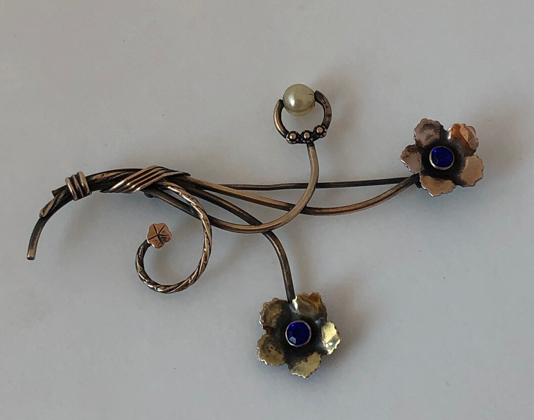 Spilla a forma di orchidea Kenneth Jay Lane vintage - Pomella Vintage Shop Spilla a forma di orchidea Kenneth Jay Lane vintage - Pomella Vintage Shop