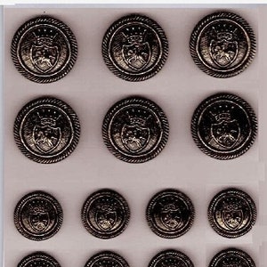 May include: A set of 14 dark antique brass buttons. Six large buttons are 13/16 inches in diameter and eight smaller buttons are 5/8 inches in diameter. The buttons feature a raised design of a crown and shield.
