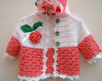 Crochet baby sweater. Pink and white cotton with a raised rose applied. Crochet fashion for girls. Romantic sweater for baby girls