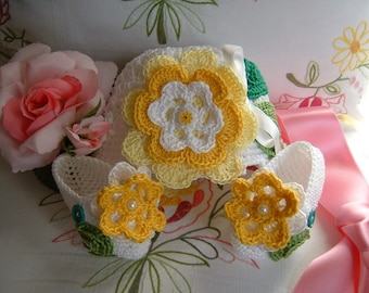 Hand crocheted hat and shoes in white cotton with yellow flowers applied. Crochet summer baby fashion