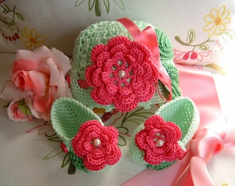 Hand crocheted hat and shoes in light green cotton with fuchsia flowers applied. Crochet summer baby fashion