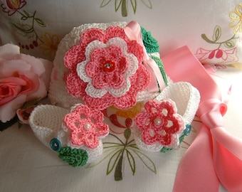 Hand crocheted hat and booties in white cotton with pink flowers applied. Crochet baby fashion summer