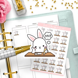Puede incluir: Una hoja de pegatinas para planificador con un conejo blanco con orejas rosas sentado en un escritorio con un lápiz y una burbuja de pensamiento que dice "1+1=?". Las pegatinas están sobre un fondo rosa con el texto "I'm at the Moon Co."
