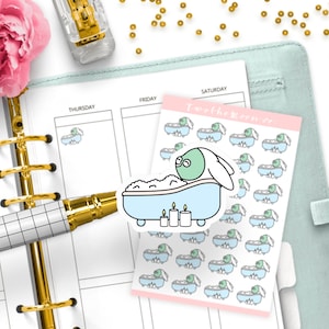 May include: A sheet of stickers featuring a cartoon bunny taking a bath with candles. The stickers are on a pink background with the text "I'm the Moon Co.".