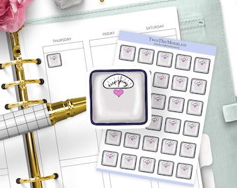 May include: A planner spread featuring stickers with a scale design and the words "keep going" above a pink heart. The stickers are white with a navy blue border. A sheet of stickers and a single sticker are visible.