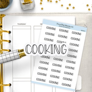 May include: A planner with a gold binder, a pen, and stickers. The stickers include the word "COOKING" in a bubble design and a sheet of stickers with the word "COOKING" repeated. The planner is open to a Thursday and Friday page.